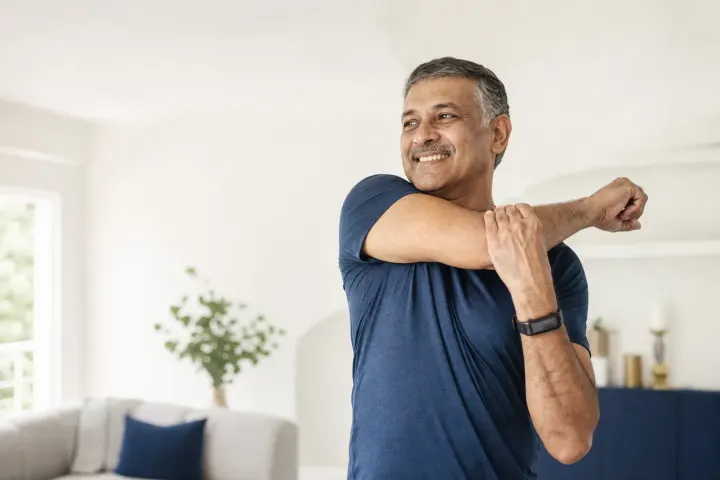 Man holding his lower back and hip from sciatica nerve pain before treatment in Naples FL