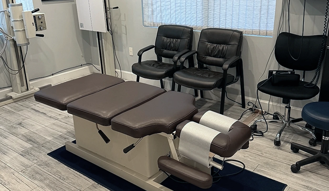 Adjustment table and patient seating at Bergtold Chiropractic in Naples, FL